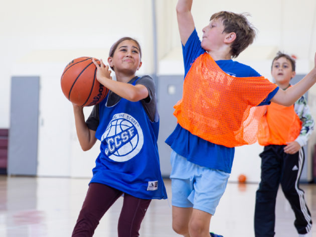 Kids playing basketball at camp