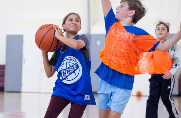 Kids playing basketball at camp