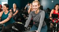 Smiling woman in spin class