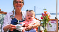 Woman holds baby in lap at Sukkot popup