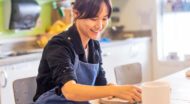 Smiling woman works on ceramics project