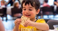 Young boy eats bread at Passover gathering