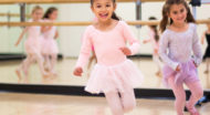 Little girls smiling and dancing in the studio.