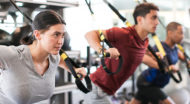 man and woman using fitness equipment