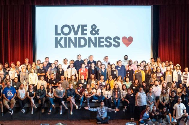 JCCSF group poses in front of screen reading "Love & Kindness"