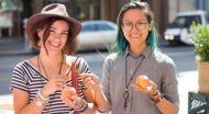 Two people holding apples