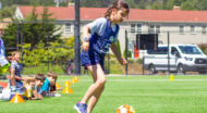 kids playing soccer on a sunny field