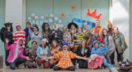 Staff members dressed in Purim costumes pose for a group photo.